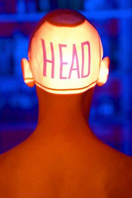 Back of bald man head with projection of word head.jpg