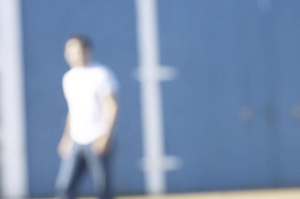 Blur of person walking past blue and white barn.jpg