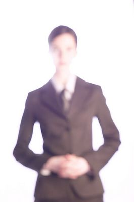 Blurred businesswoman in suit.jpg