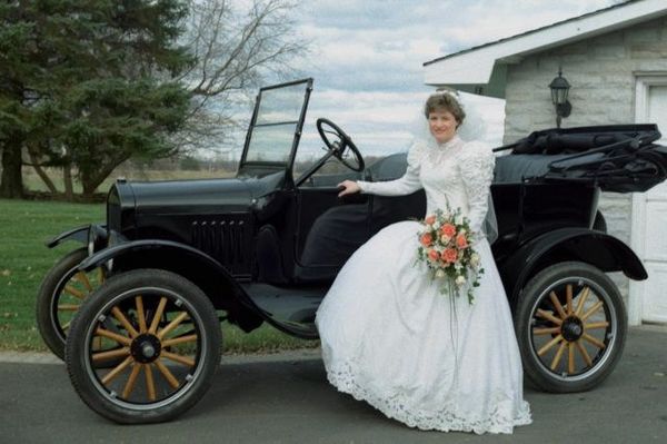 Bride standing next to 1920 car.jpg