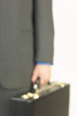 Businessman hand holding briefcase.jpg