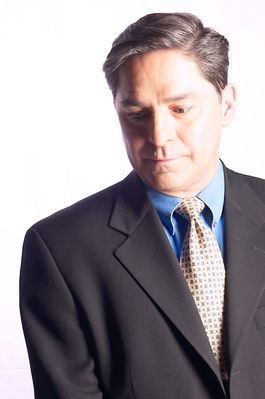 Businessman in suit and tie looking downwards.jpg