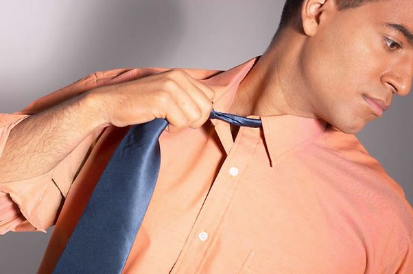 Businessman loosening his tie 2.jpg
