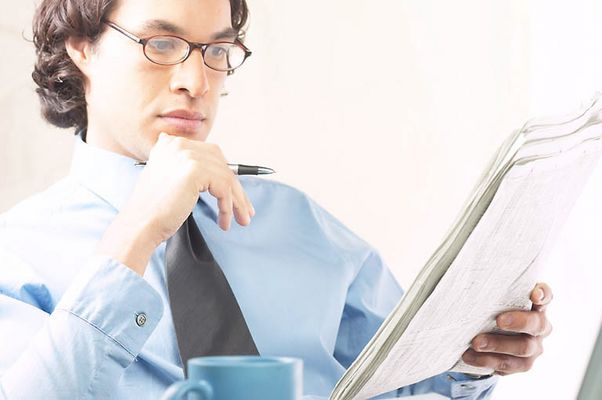 Businessman reading newspaper 2 c103129.jpg