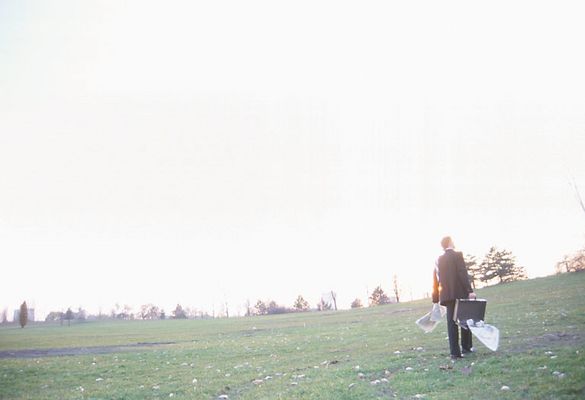 Businessman standing in field with open briefcase 4.jpg