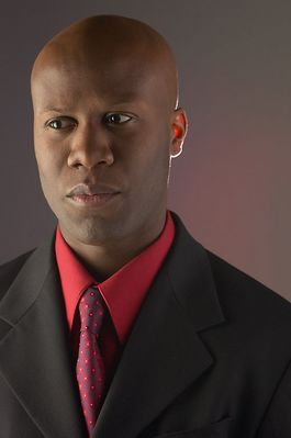 Businessman wearing red shirt and tie under black suit c102979.jpg