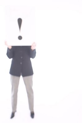 Businesswoman holding white sign with exclamation mark 1.jpg