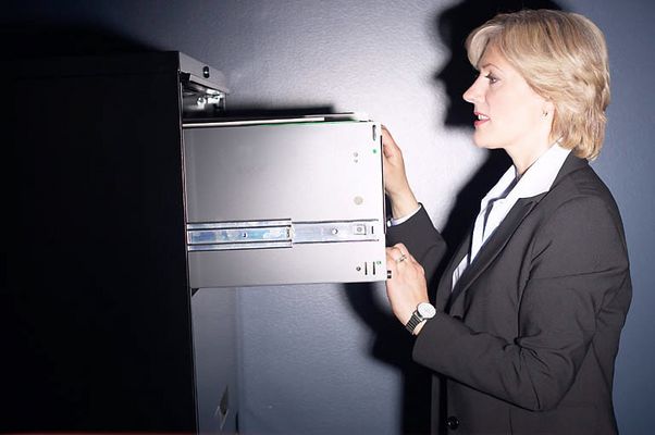 Businesswoman opening safe.jpg
