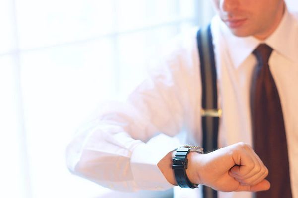 Caucasian businessman checking time on wristwatch.jpg