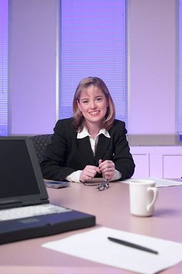 Caucasian businesswoman at board table during job interview.jpg