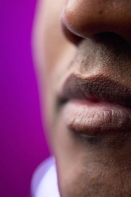 Close up of South Asian man lips against purple background 1.jpg