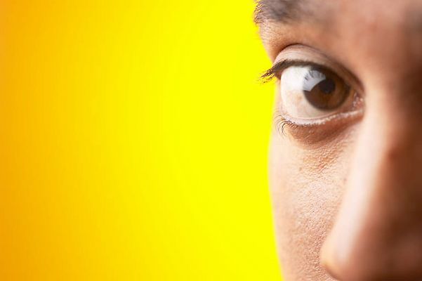 Close up of half of South Asian man face against yellow backgr 4.jpg