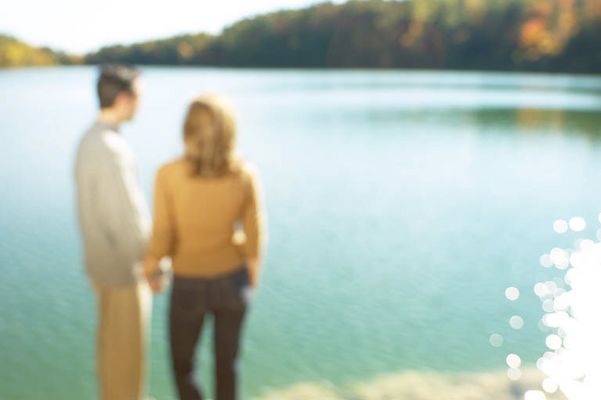 Couple holding hands and looking out at water.jpg