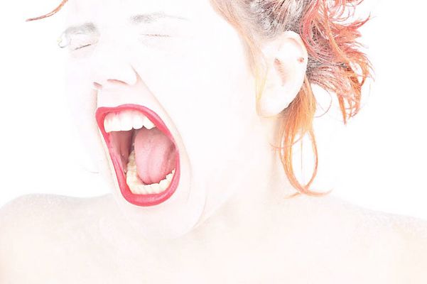 Headshot of Caucasian woman yelling with eyes closed.jpg