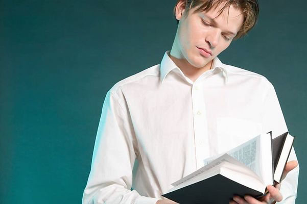 Male adult reading book uid 1452864.jpg