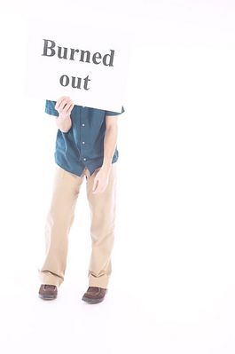 Man holding a white burned out sign over his face.jpg