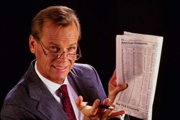 Man in suit with newspaper.jpg