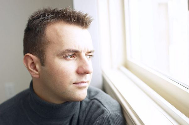 Man looking out of window c102126.jpg