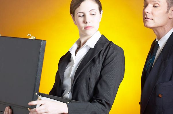 Man spying into woman briefcase.jpg