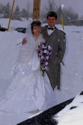 Newlyweds standing in snow.jpg