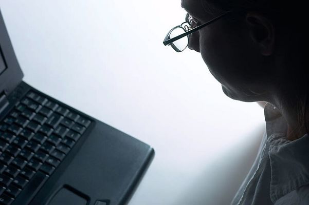 Profile of Caucasian businesswoman using laptop computer.jpg