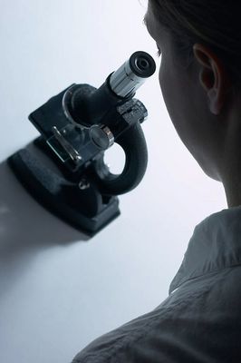 Profile of woman using black microscope.jpg