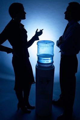 Silhouette of people talking at water cooler.jpg