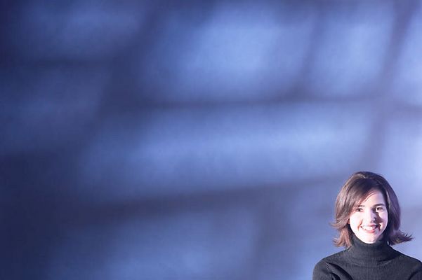 Smiling woman against blue wall.jpg