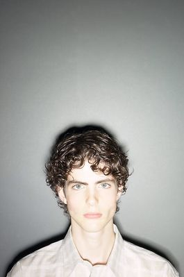 Teenaged boy against gray wall 3.jpg