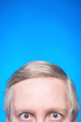 Top half of elderly Caucasian man face against blue background 2.jpg