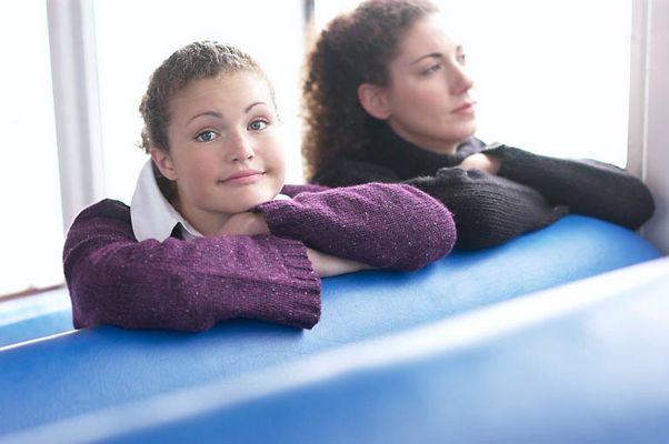 Two women sitting in blue vinyl seats.jpg