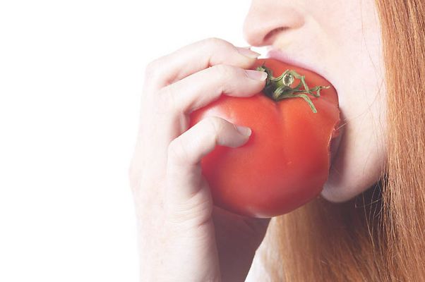 Woman biting tomato uid 1343064.jpg