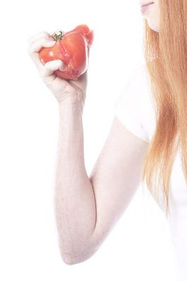 Woman eating tomato uid 1343067.jpg