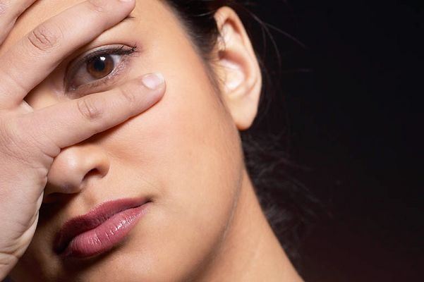 Woman eyes peeking out through fingers uid 1426301.jpg