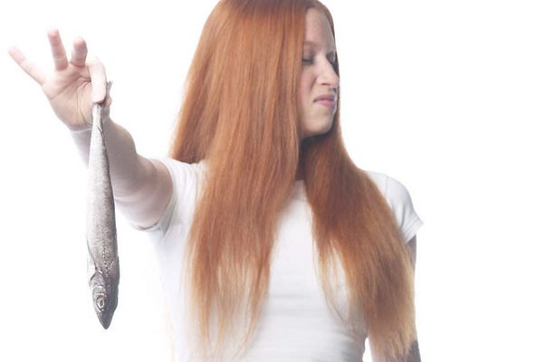 Woman holding fish and plugging nose uid 1343071.jpg