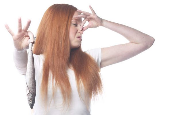 Woman holding fish and plugging nose uid 1343072.jpg
