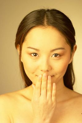 Woman holding hand to mouth uid 1344517.jpg