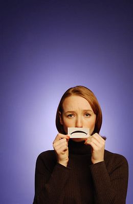 Woman holding paper frown to her face uid 1173071.jpg