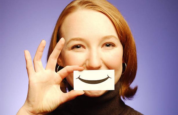 Woman holding paper smile to her face 5.jpg