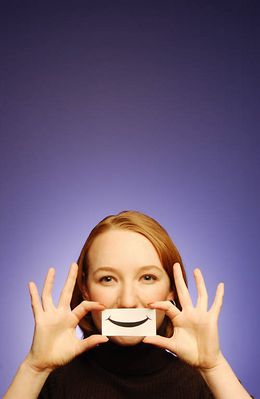 Woman holding paper smile to her face 6.jpg