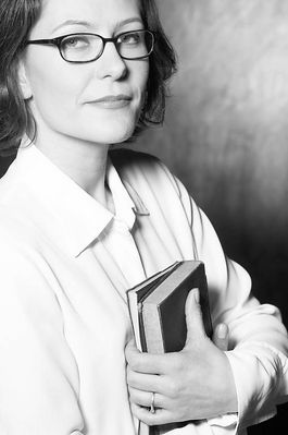 Woman in eyeglasses holding books.jpg