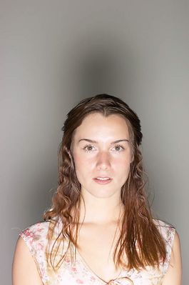 Woman in floral top with light shining.jpg