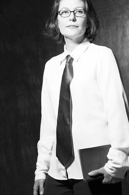 Woman in tie holding book.jpg
