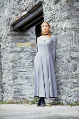 Woman leaning against stone wall.jpg