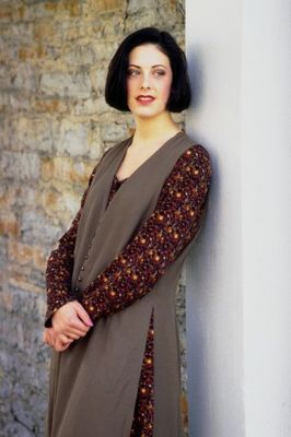 Woman leaning against white column.jpg