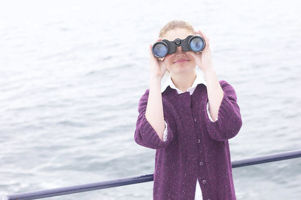 Woman looking through binoculars on boat uid 1283650.jpg