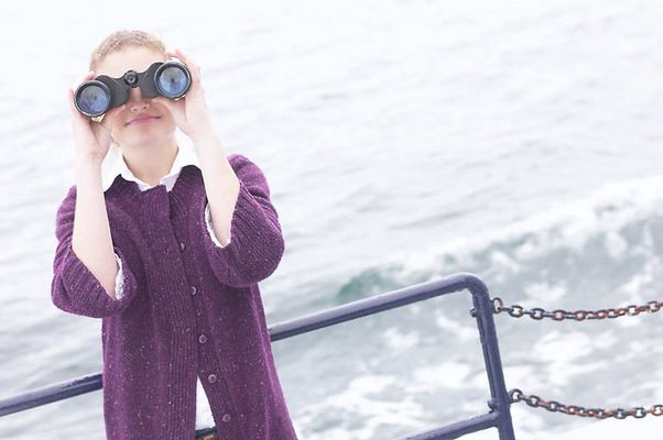 Woman looking through binoculars on boat uid 1283651.jpg