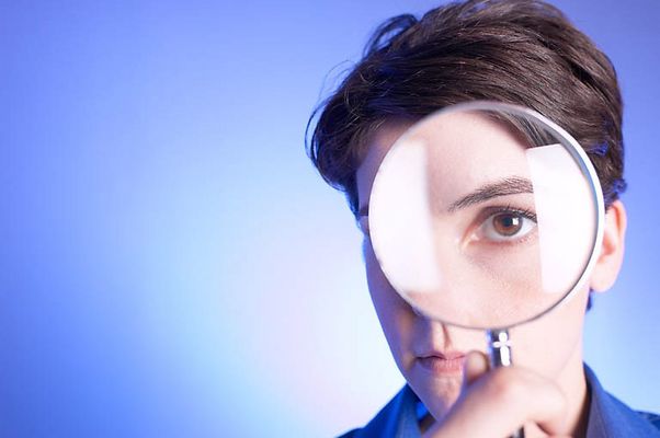 Woman looking through magnifying glass.jpg