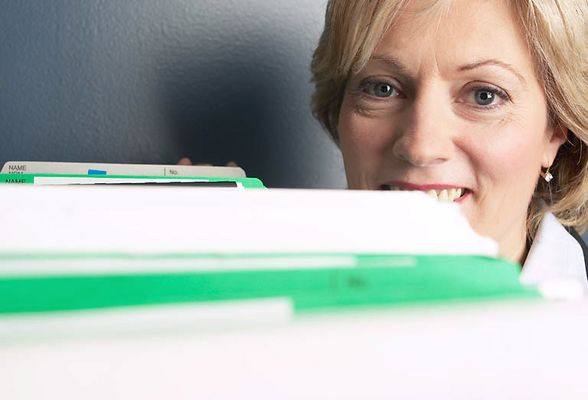 Woman peeking over files.jpg