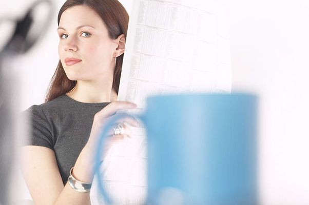 Woman reading newspaper at her desk 9.jpg